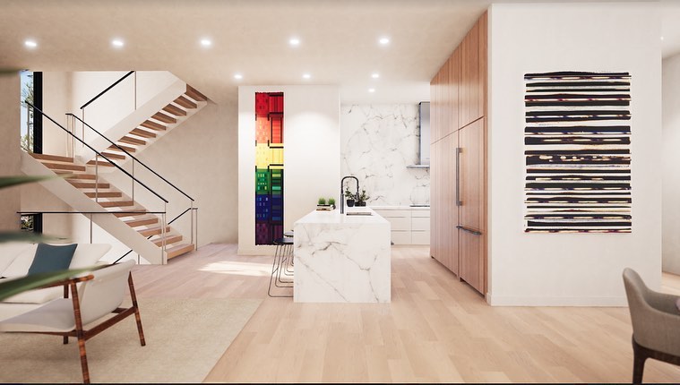 Cocina abierta con isla de mármol, escaleras flotantes y gabinetes de madera